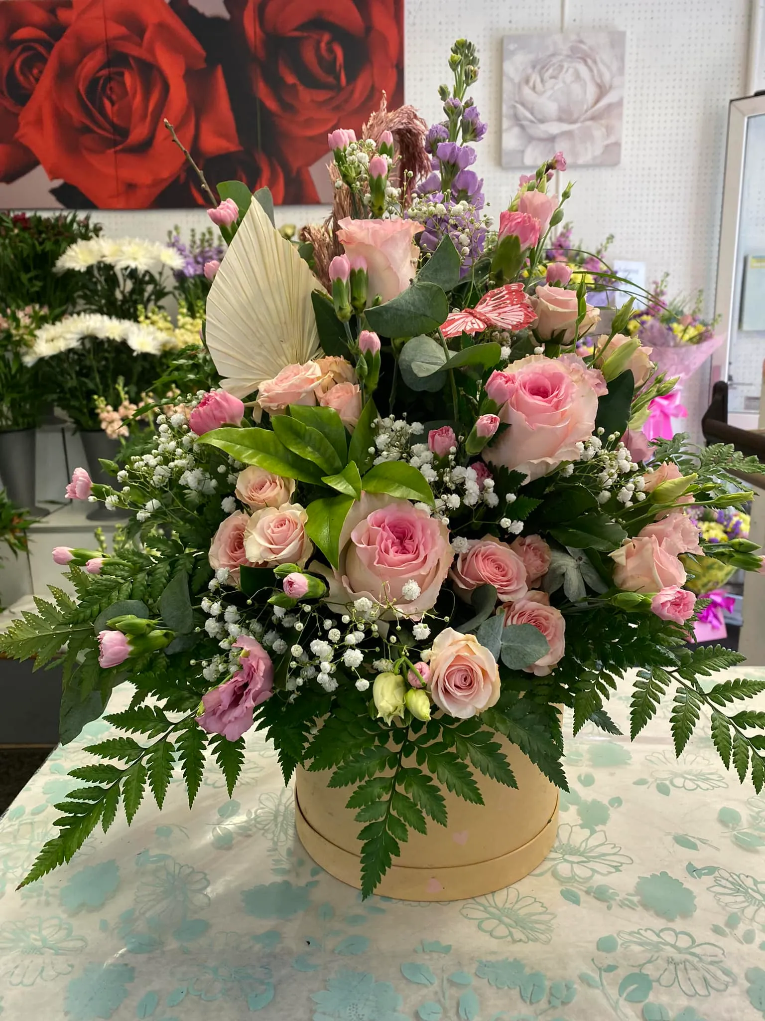 A bouquet of flowers on a table in a room.
