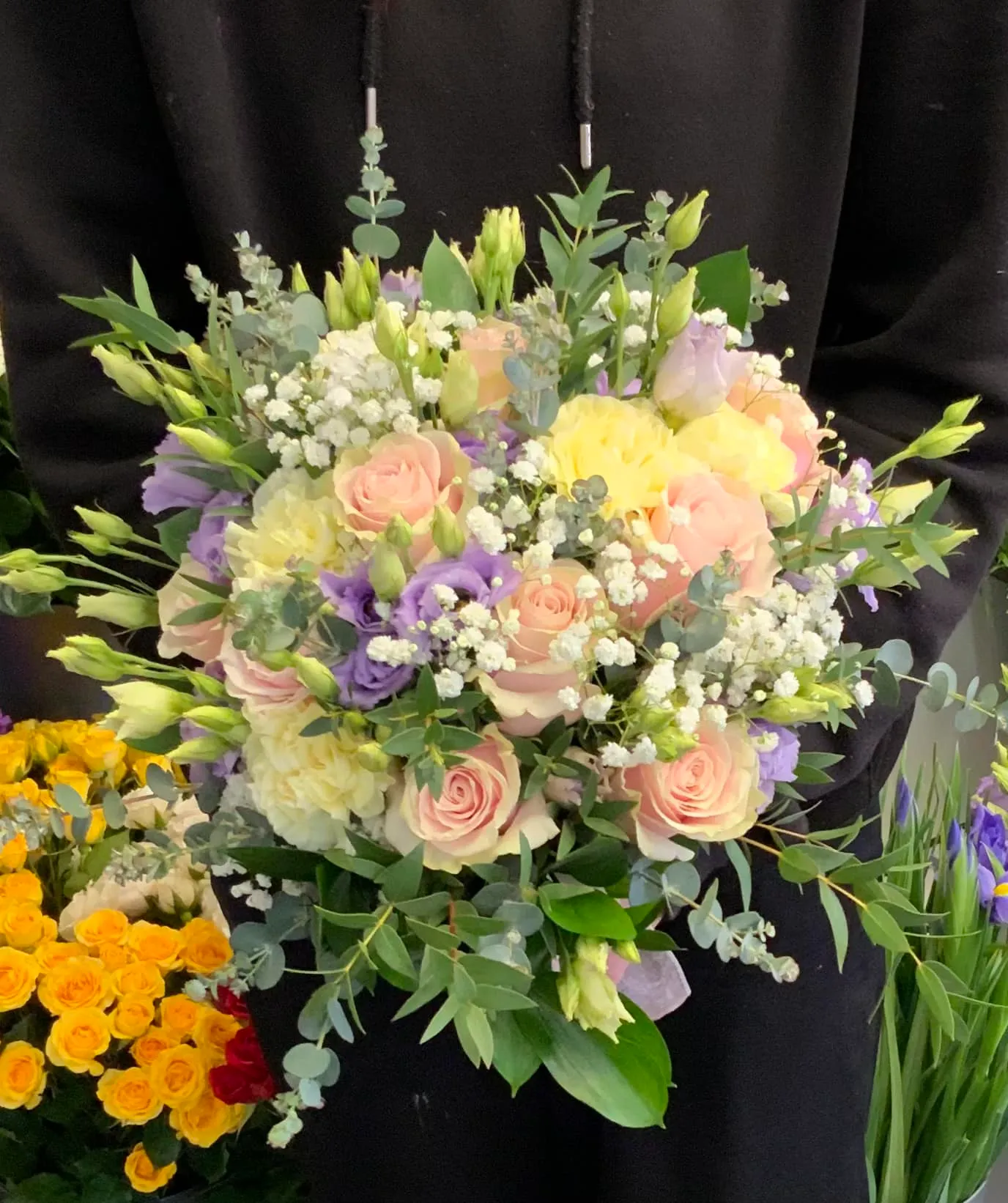 a person holding a bouquet of flowers in their hands