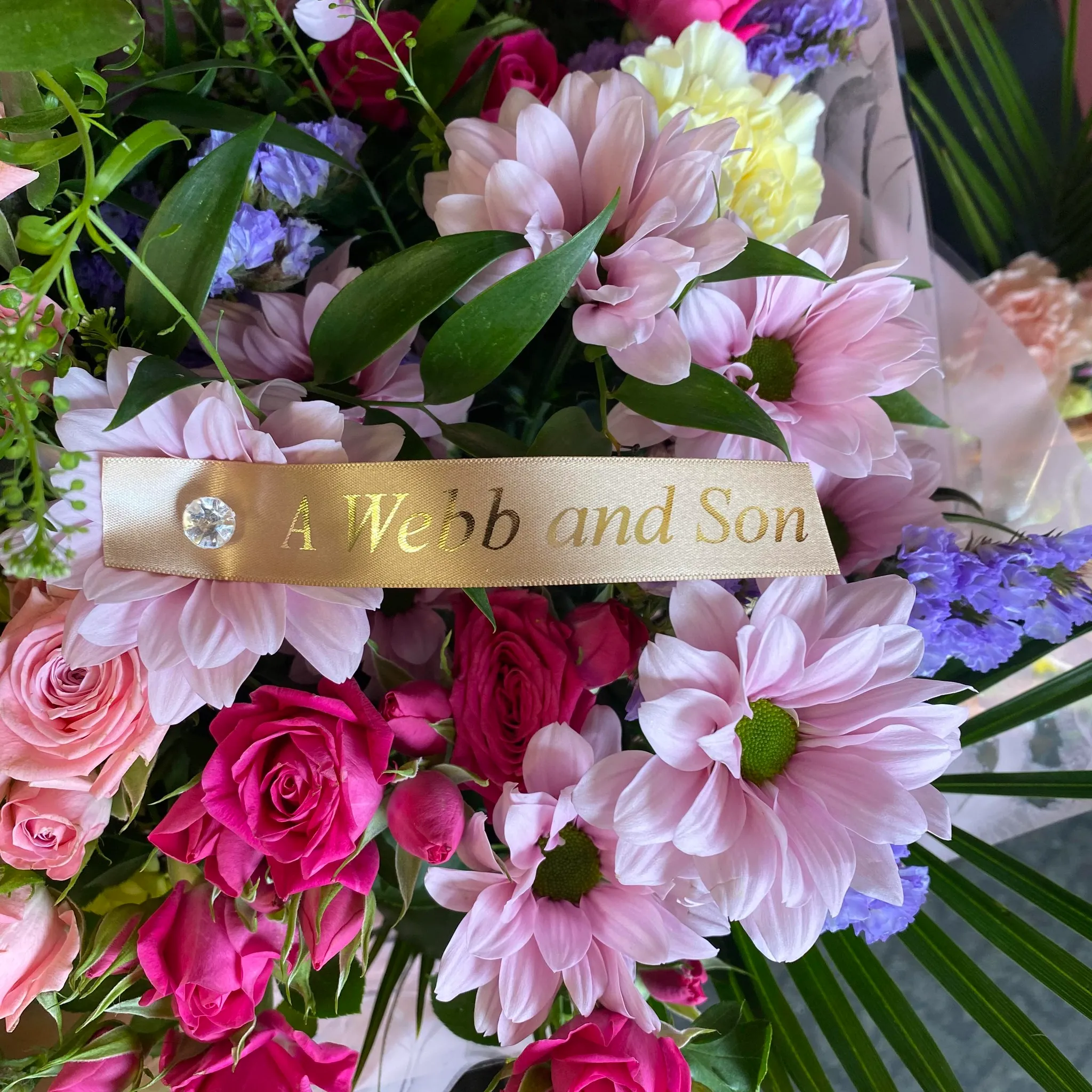 A bouquet of flowers with a name tag on it.